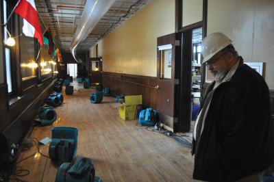 Rev. Jack Ahern surveyed the damage on the second floor of St. John Paul II Catholic Academy’s Columbia campus on Monday morning.                                                                                        Bill Forry photo